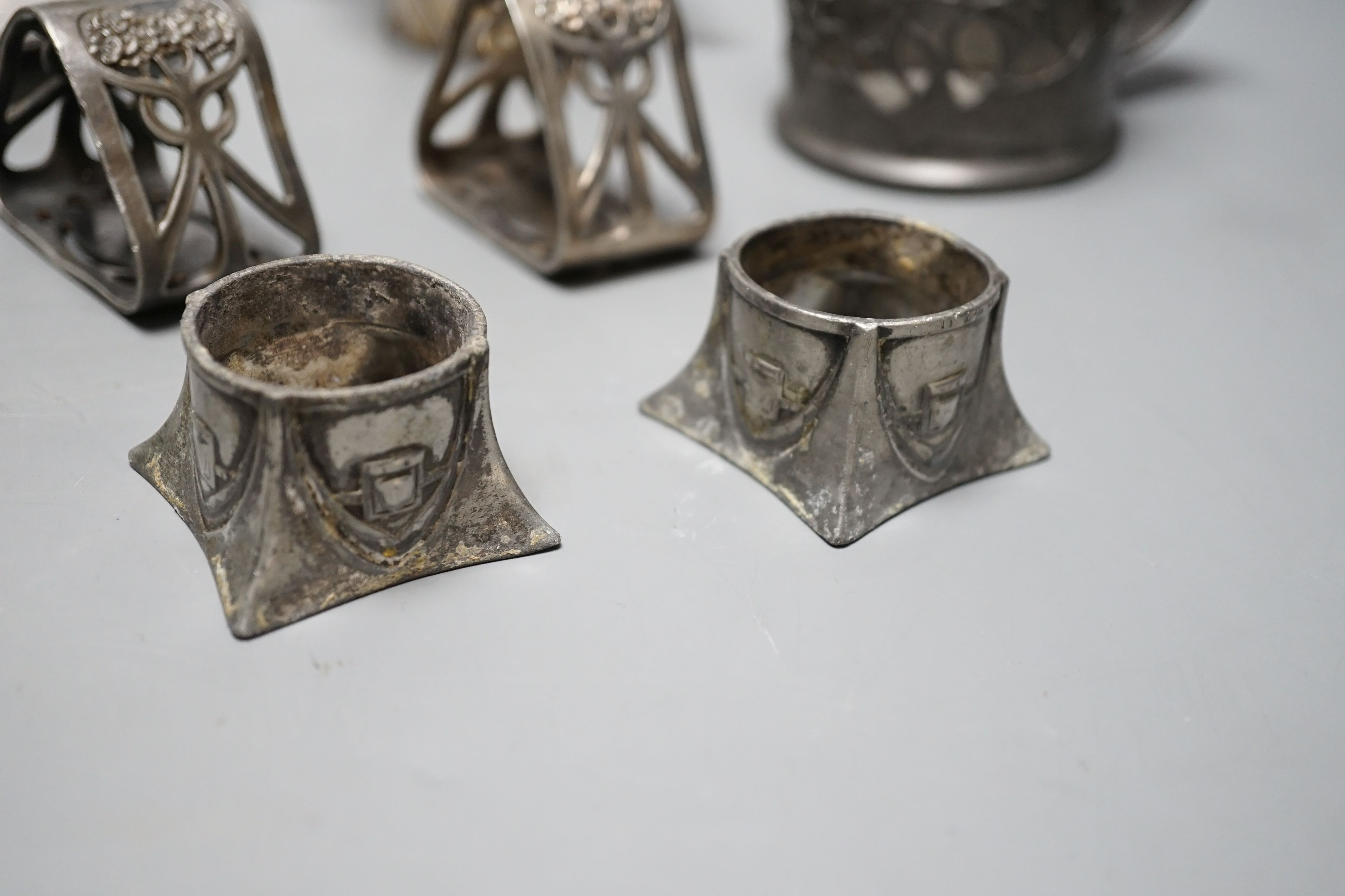 An Arts and Crafts Tudric pewter mug, stamped 534, a pair of WMF napkin rings together with other pewter and metal items, pewter mug 8cms high (9)